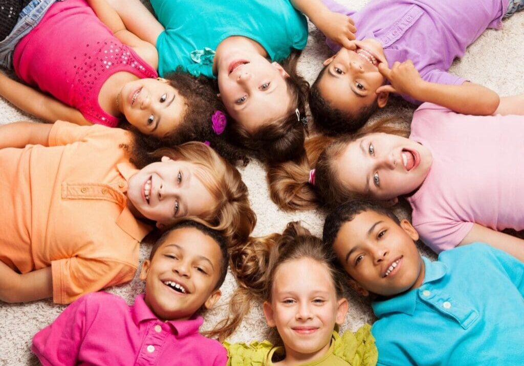 A group of children laying in the middle of a circle.